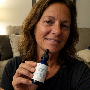 MemoFlow customer photo holding the memory drops bottle
